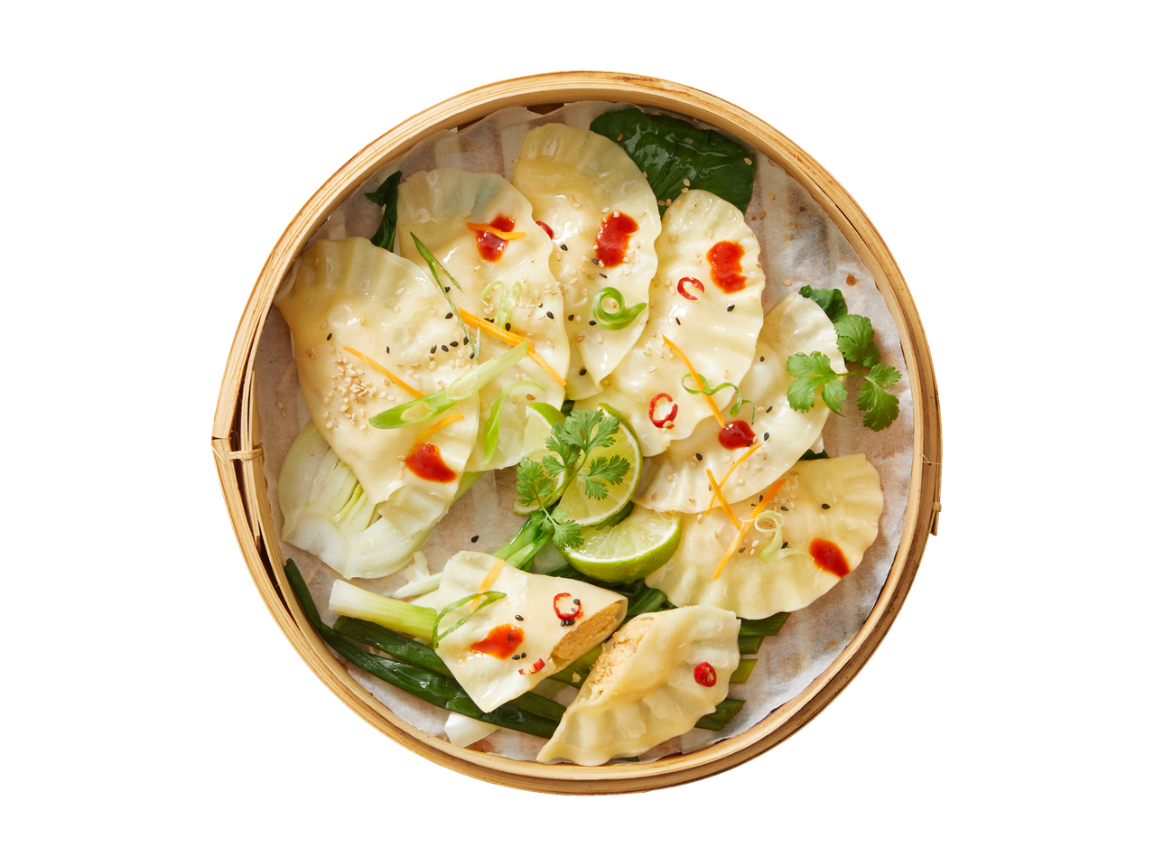 Vitasia Dim Sum in a bamboo steamer, garnished with lime, chili, and spring onion.