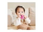 Baby in a white top and brown overalls, chewing on a pink teether.