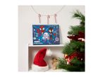 Spider-Man advent calendar, Santa hat, and teddy bear on a shelf with a Christmas tree.
