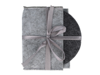 Light gray felt coasters tied with a ribbon, with a dark gray coaster peeking out.