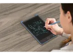 A woman sketches a building design on a LCD writing tablet.