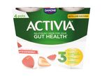 Four-pack of strawberry yogurt with text highlighting gut health benefits and real fruit pieces.
