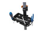 Bicycle repair stand with a tool tray holding a screwdriver, wrenches, nuts, washers, and pliers.