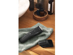 Cien BEAUTY Hair & Beard Trimmer on a towel with shaving accessories in the background.