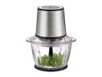 Food chopper with a stainless steel motor unit and glass bowl containing parsley.