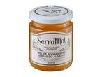 Jar of honey with a white label featuring flowers and text, on a white background.