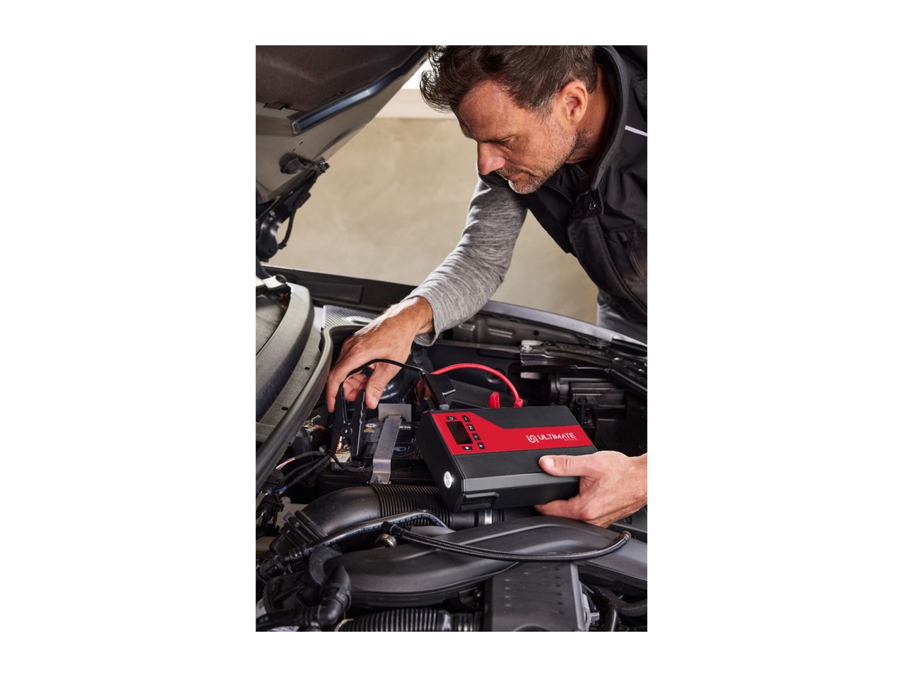 Man jump-starting a car with an Ultimate Speed jump starter.