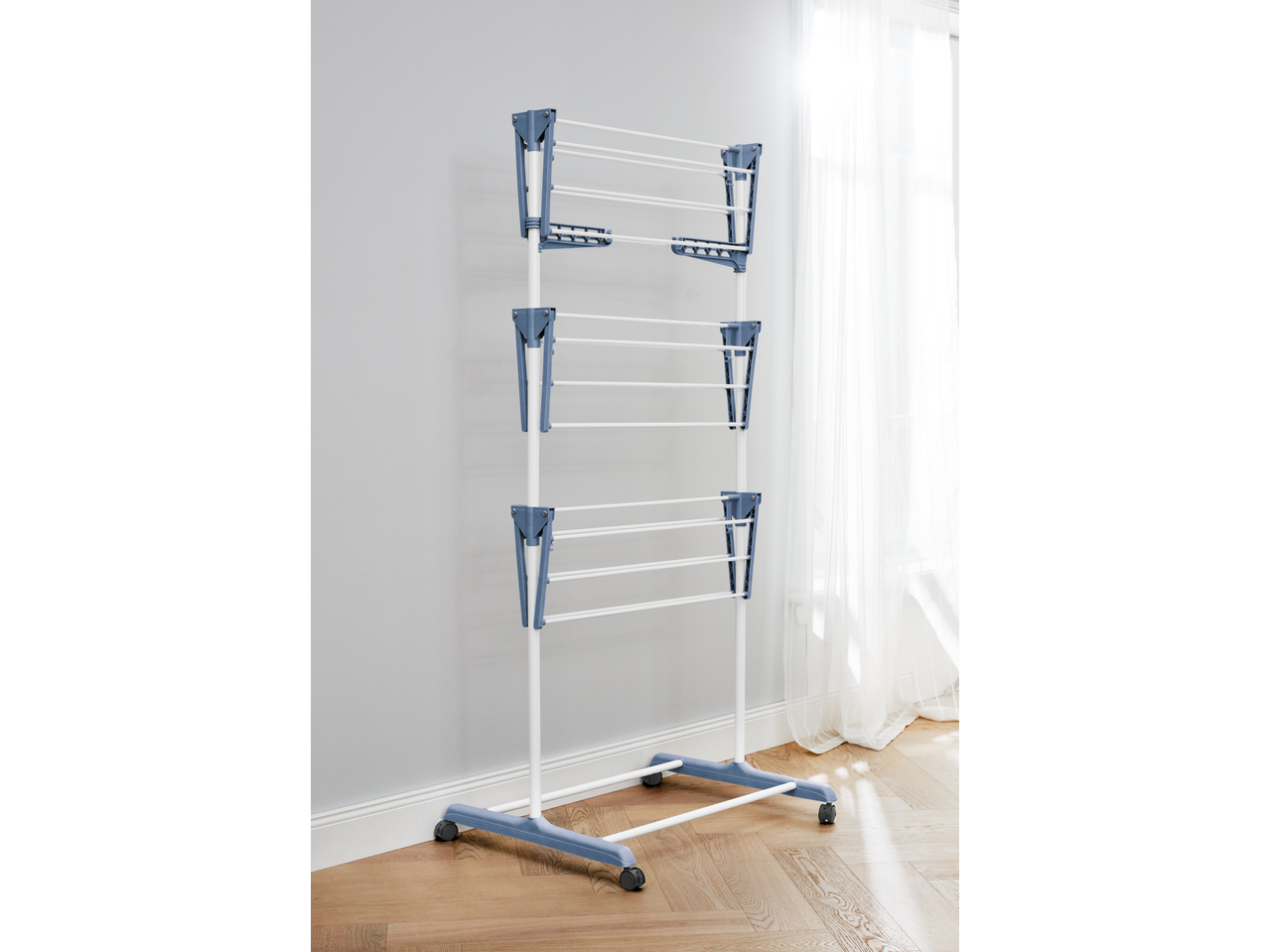 W5 3 Tier Clothes Airer, white and blue, standing on a wooden floor.