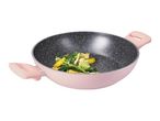 A pink wok with a speckled interior, containing stir-fried vegetables.