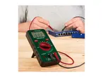 A person using a digital multimeter to test a network switch.