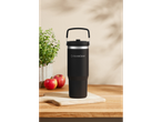 A black SilverCrest travel mug with a handle sits on a wooden cutting board.