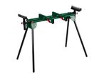 Green and black saw stand with roller supports on a white background.