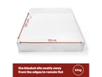 A white electric blanket with dimensions 137 cm by 135 cm on a mattress, with text about it remaining flat.
