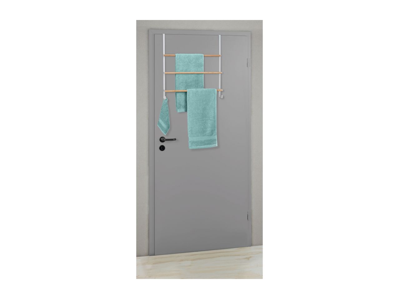 Over-the-door towel rack with three light blue towels on a grey door.
