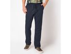 Men's navy blue drawstring trousers with a striped t-shirt and brown sneakers