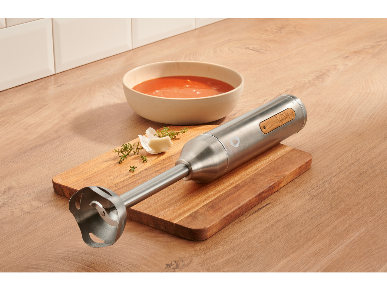 SILVERCREST® 600W Hand Blender Set with a bowl of soup, garlic, and thyme on a wooden board.