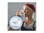 A person drinking water from a glass, with a water filter cartridge shown in a circular overlay.