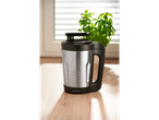 SilverCrest soup maker on a wooden surface with a plant and window in the background.