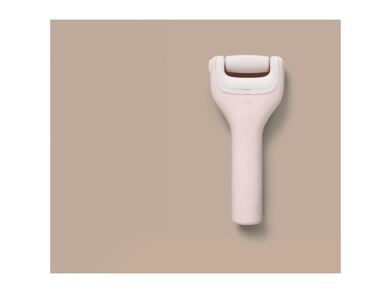 Pink electric foot file with a white roller and power button on a beige background.