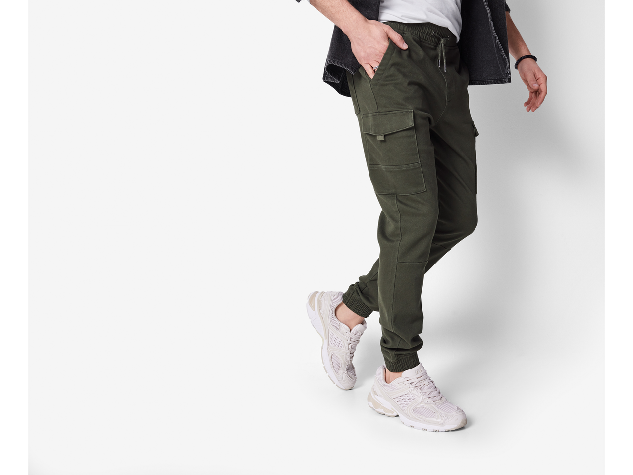 Men's Esmara joggers in olive green with white sneakers.