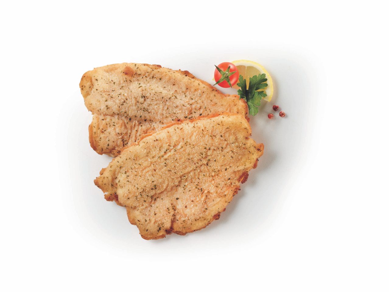 Due cotolette impanate con guarnizione di pomodoro, limone e prezzemolo.