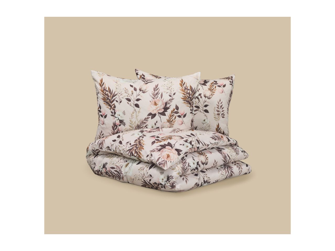 Floral patterned bedding set with two pillows and a folded duvet