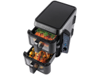 A Salter digital air fryer with two stacked drawers, cooking a roast chicken and vegetables.