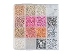 A clear plastic organizer box filled with various colorful beads, silver charms, and string for crafting.