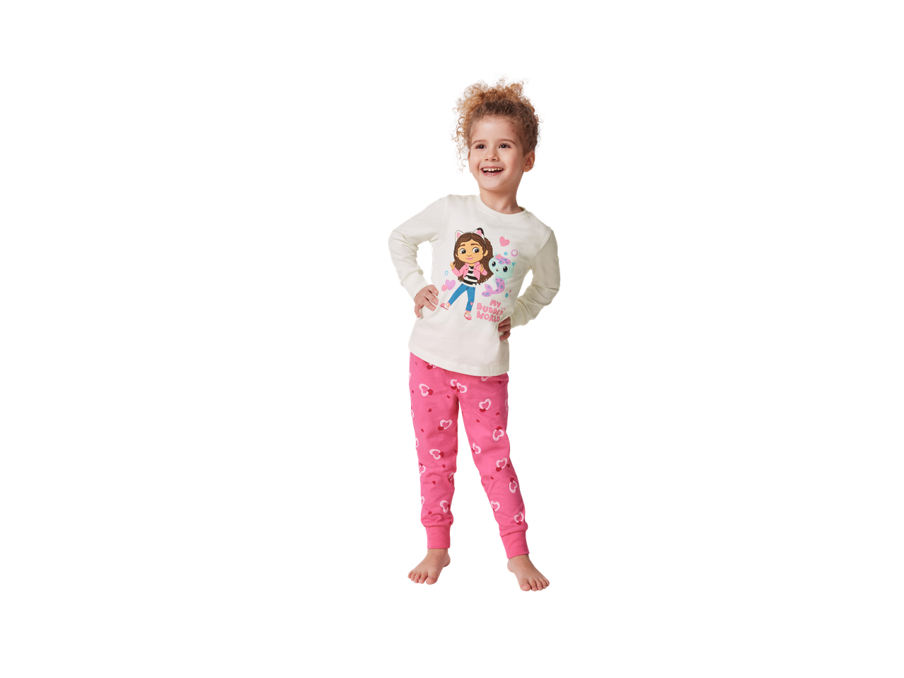 A child in Gabby's Dollhouse themed pajamas with a white top and pink heart-patterned bottoms.