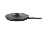 Black electric kettle base with power cord on a black background