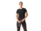 Woman in a black CRIVIT short sleeve sports top and dark leggings holding a water bottle.