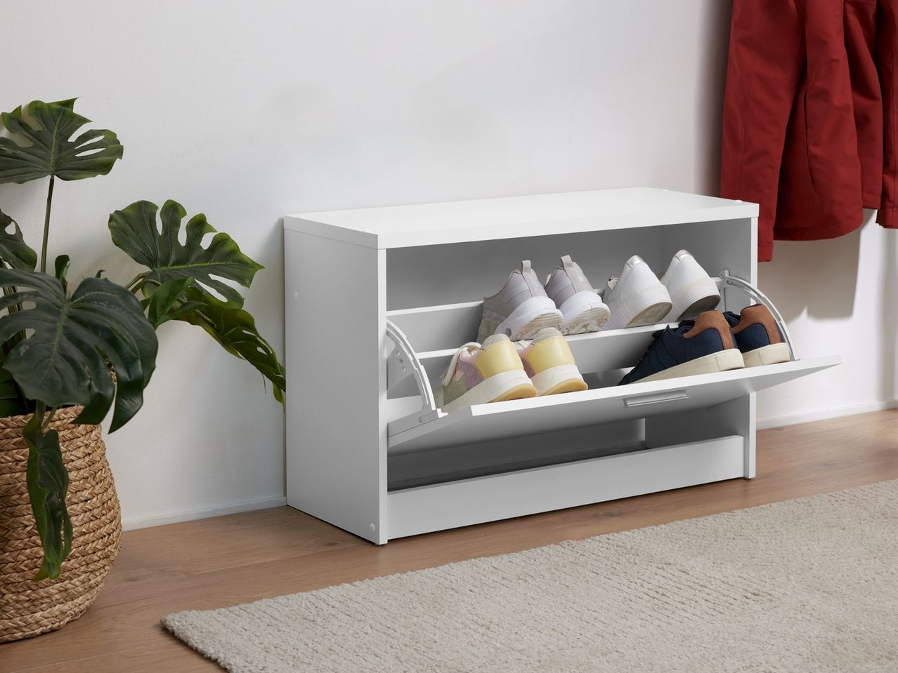 White modern shoe storage cabinet with pull-out drawers.