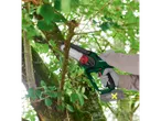 A person cuts a tree branch with a cordless wood cutter.
