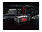 Ultimate Speed car battery charger connected to a car engine.