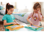 Two girls use Paw Patrol-themed magnetic drawing boards.