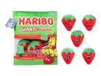 Green plush bag of giant strawberry plushies with various facial expressions.
