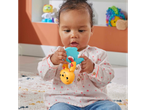 Baby playing with a colorful rabbit and bird-shaped rattle.