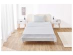 A single bed with a white floral duvet cover and matching pillowcases.