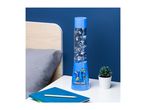 Minecraft lava lamp on a bedside table with a notebook and a small plant.