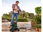 Man cleaning with a Parkside pressure washer.