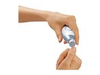 Woman using an electric nail file on her fingernail.