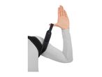 Person wearing a posture corrector, with one arm raised, showing the strap around the thumb.