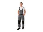 Man in grey and black work overalls with a white t-shirt and black work shoes.