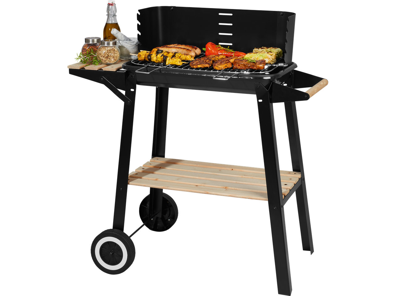 Black barbecue grill with various meats and vegetables cooking, and spices on a side shelf.