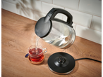 SILVERCREST® Colour Changing Glass Kettle pouring hot water into a cup of tea.