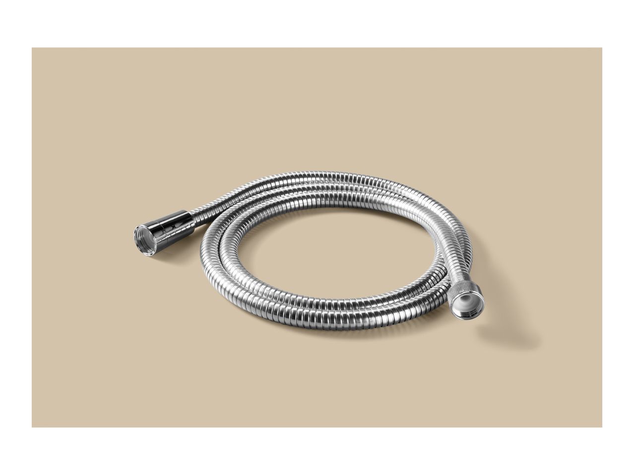 Silver flexible shower hose coiled on a beige background.