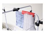 White clothes drying rack with a red sock holder, holding white socks and a blue shirt.