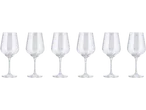 Six clear wine glasses with long stems on a black background.