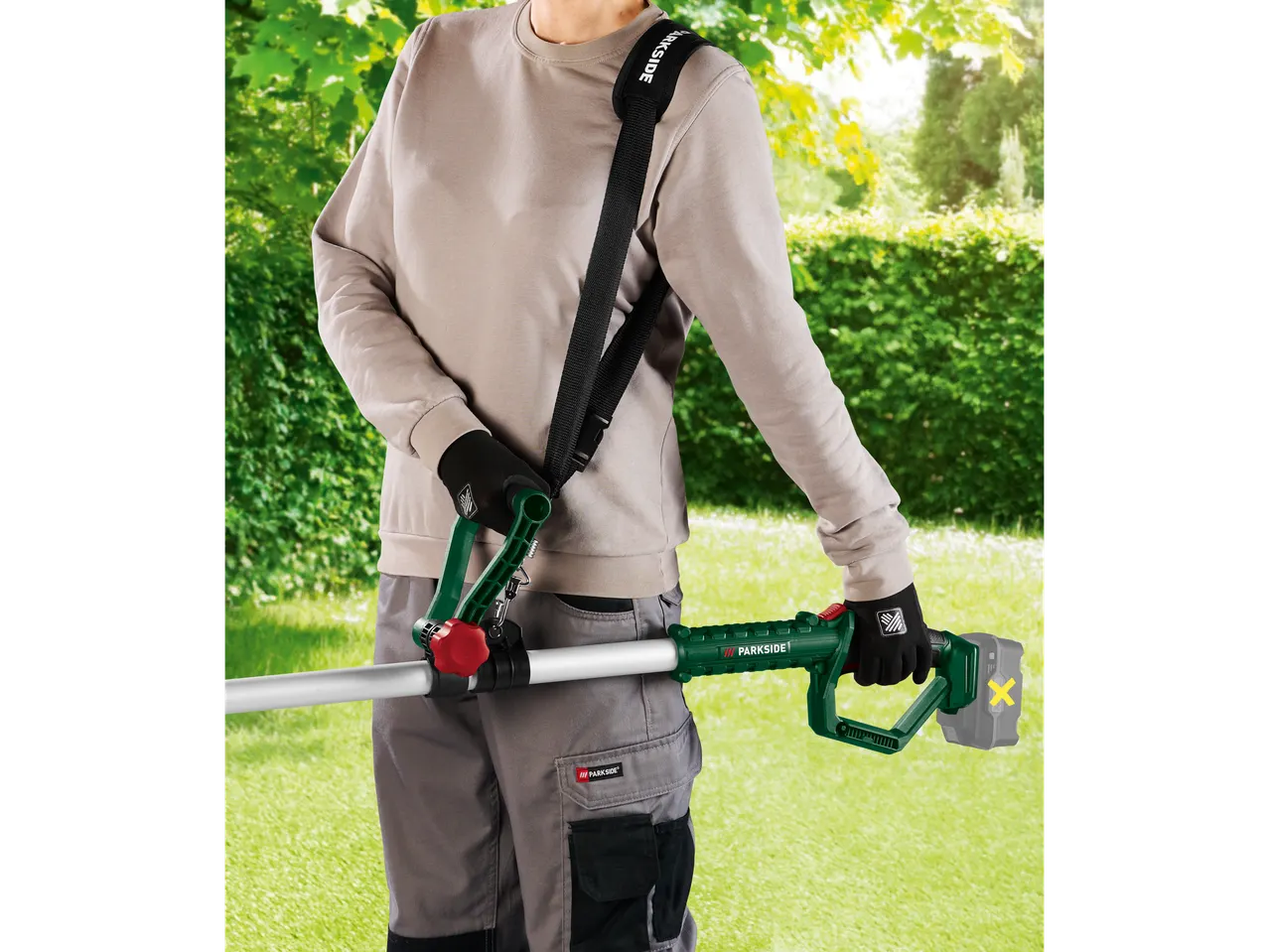 Person with PARKSIDE® cordless pole saw in a garden