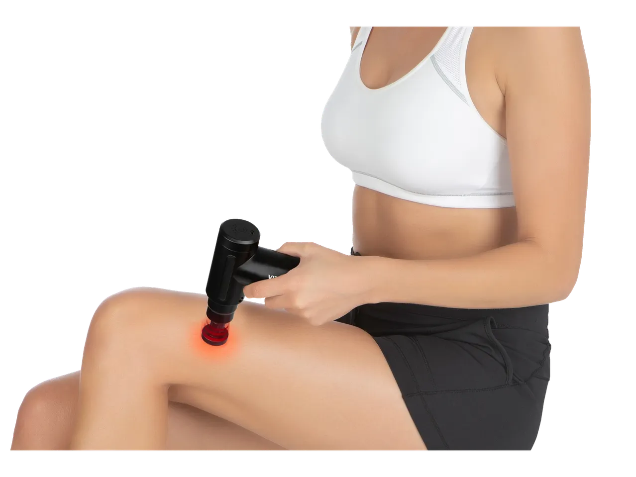 Woman using a VITALMAXX® mini massage gun with red light therapy on her leg.